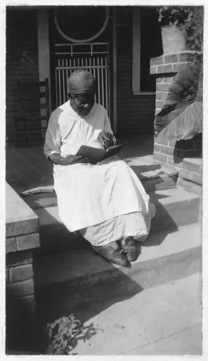 Archival photograph of Mary Armstrong in later life, seated on porch steps with an open book (Library of Congress)